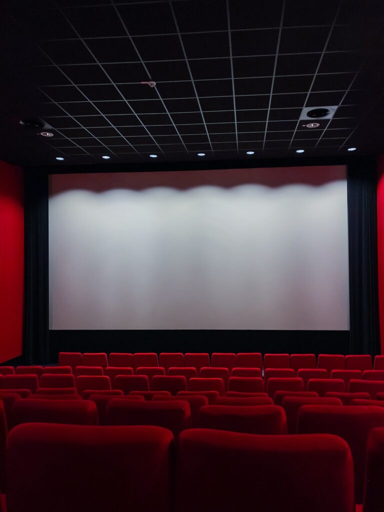 Cinema Screen And Red Seats. Empty Screening Theater